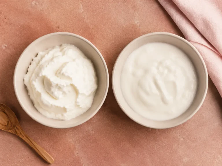 Two bowls showing thick Greek yogurt and regular yogurt for an article about Greek yogurt for PCOS.