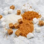 White and brown sugar cubes and granulated sugar. 