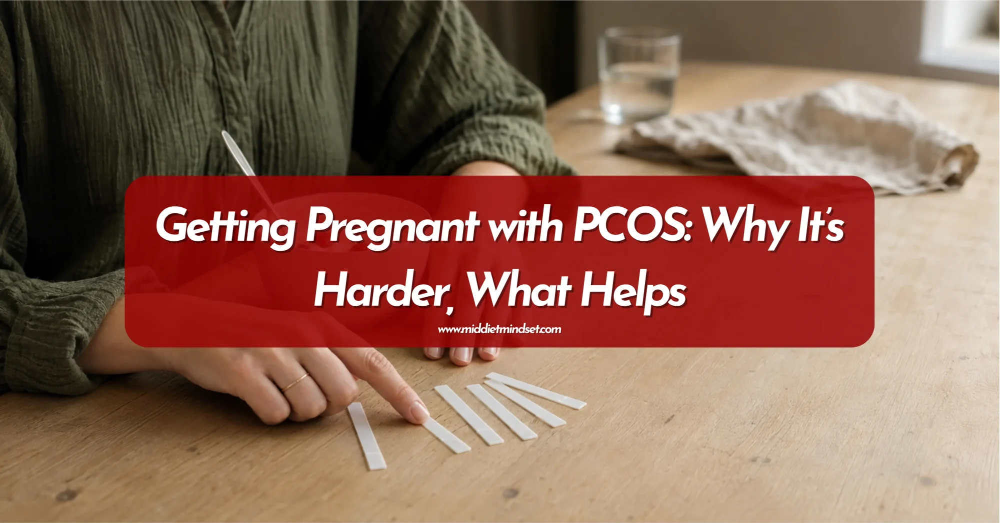 Woman reviewing ovulation test strips while trying to understand her cycle and getting pregnant with PCOS.